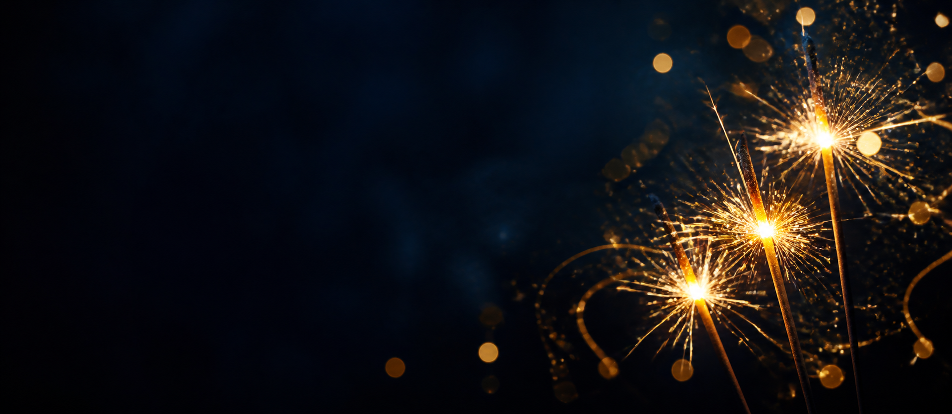 Golden sparklers against a midnight blue background
